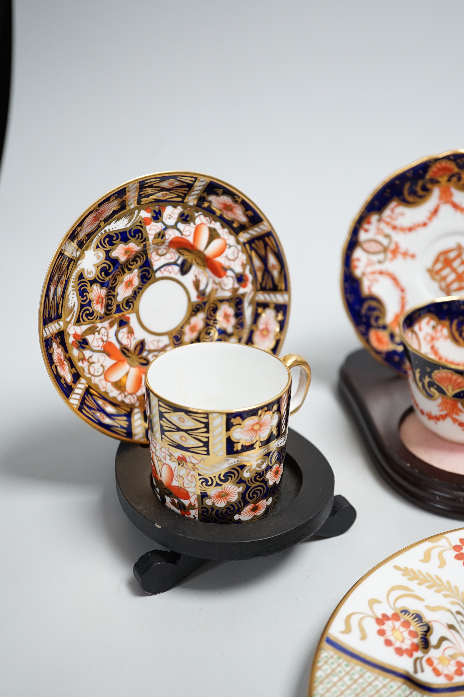 Three pairs of Royal Crown Derby porcelain cups and saucers, another Spode and a Victorian trio